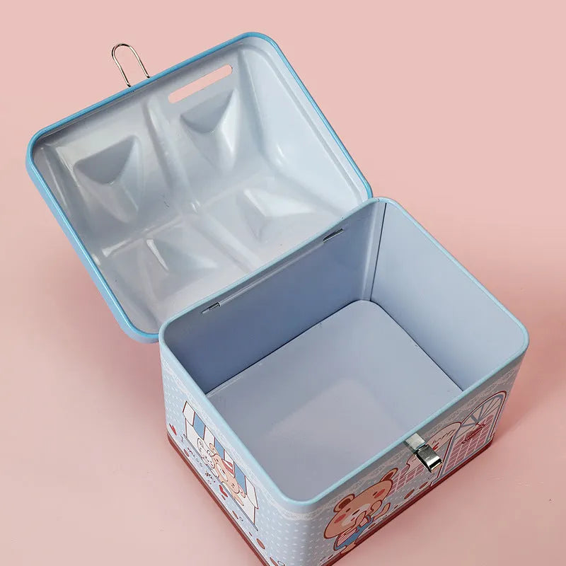 Blue house shaped tinplate piggy bank for coin storage on desktop