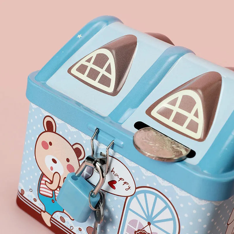 Blue house shaped tinplate piggy bank for coin storage on desktop