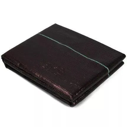 Black polyethylene woven weed proof cloth laid flat on soil, showing its texture and one of the available size options.