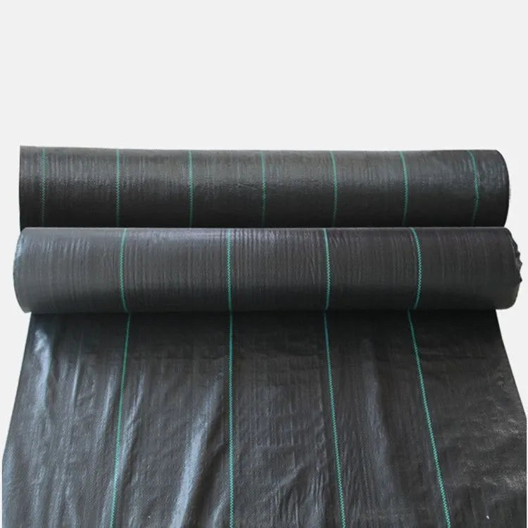 Black polyethylene woven weed proof cloth laid flat on soil, showing its texture and one of the available size options.