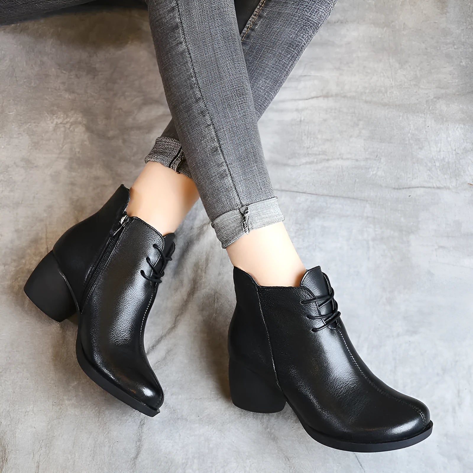 Brown women's leather Martin boots with a thick heel and round toe on a white background.