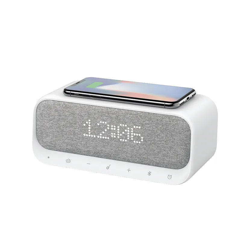 White Anker Soundcore Bluetooth speaker with wireless charging top and digital clock display