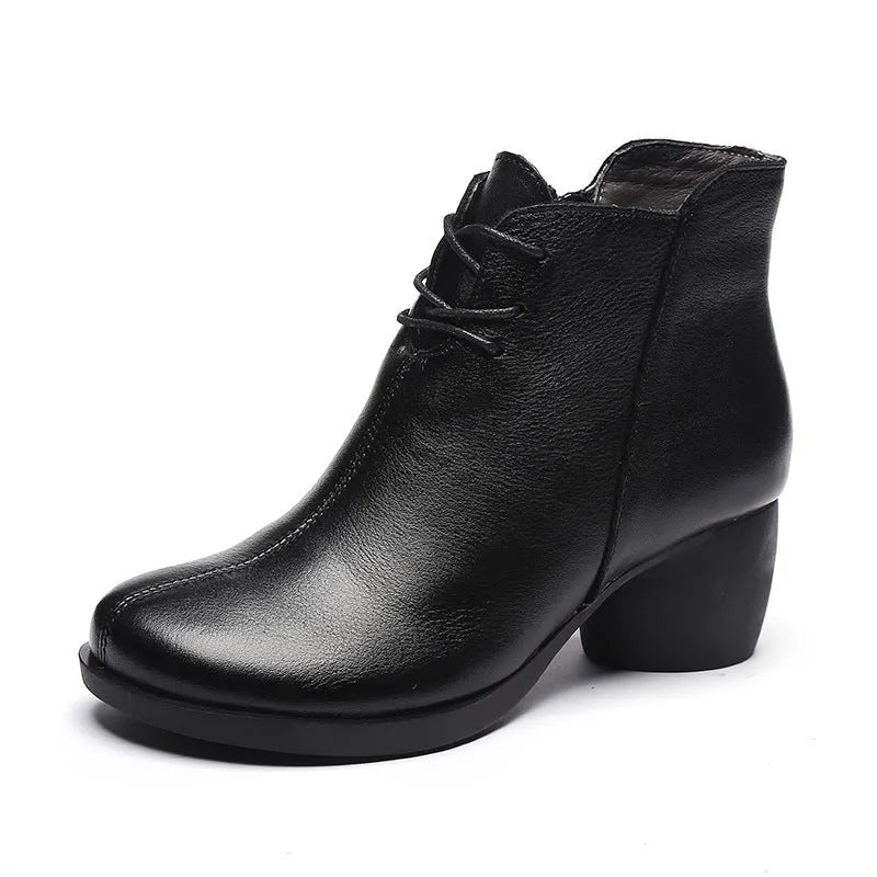 Brown women's leather Martin boots with a thick heel and round toe on a white background.