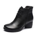 Brown women's leather Martin boots with a thick heel and round toe on a white background.