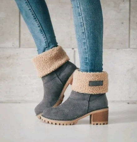 Women's black suede mid-calf snow boots with a round toe and flat low heel.