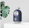 Blue and white indoor mosquito killer lamp with UV light ring, suction vents, and a silicone carry handle.