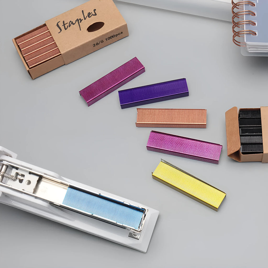 A box of 1000 metal office staples available in black, purple, rose gold, and rose red colours.