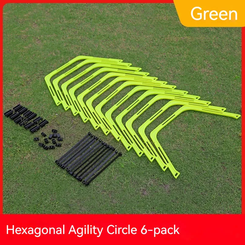 Set of six foldable yellow green and orange hexagon plastic agility training rings laid out on grass