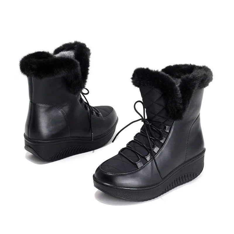 Black women's winter ankle boots with lace-up closure and a platform sole.