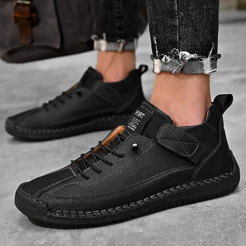 Men's mid-calf black Martin boots with tooling stitching and an elastic band side closure.