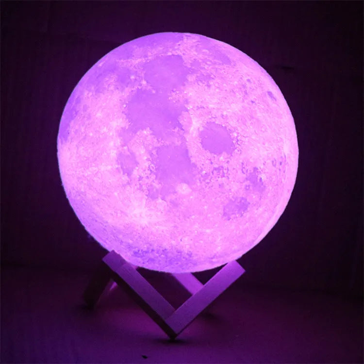 3D printed white moon lamp with detailed craters on a wooden stand, showing touch ring at base.