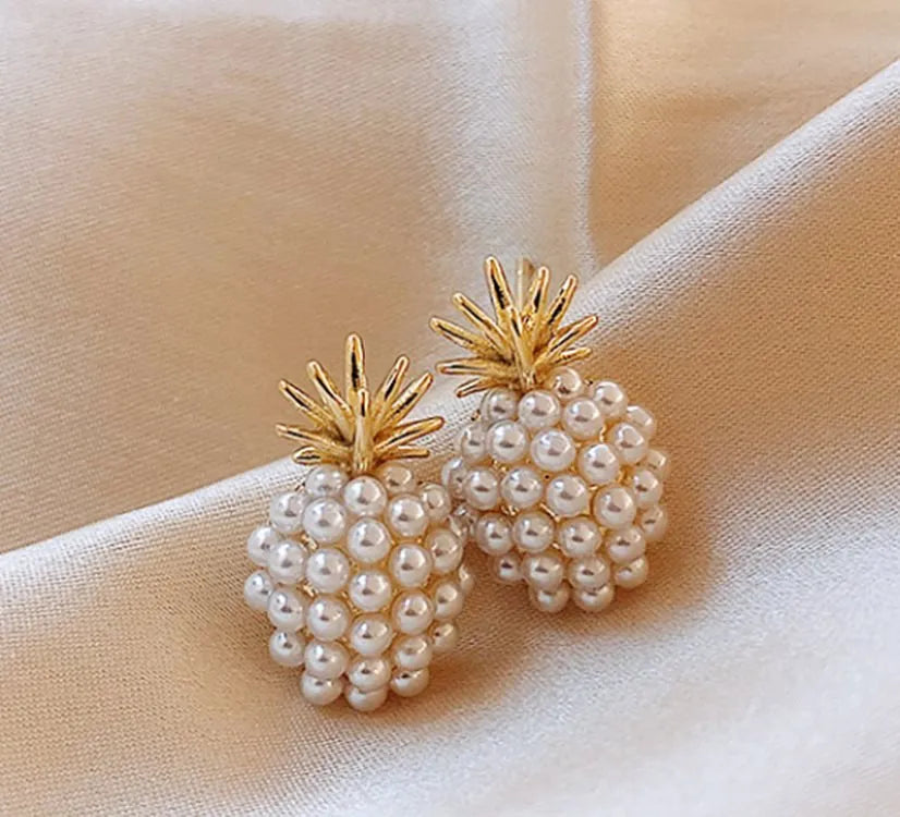 Gold colour Korean-style drop earrings featuring a pineapple and starfish design with pearl and gemstone inlay.