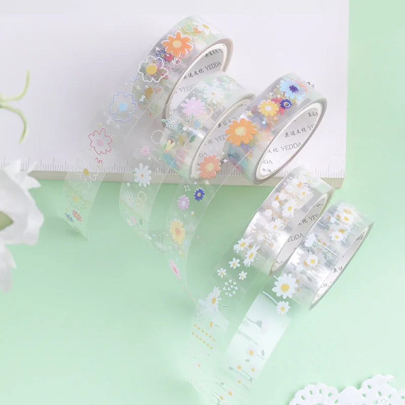 Five rolls of transparent adhesive tape with a yellow and white midsummer daisy cartoon pattern, each 1.5cm wide.