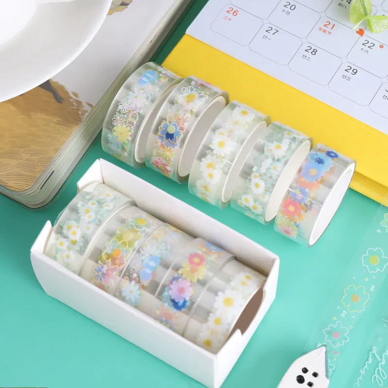 Five rolls of transparent adhesive tape with a yellow and white midsummer daisy cartoon pattern, each 1.5cm wide.