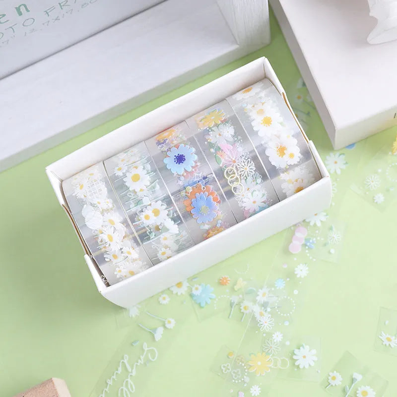 Five rolls of transparent adhesive tape with a yellow and white midsummer daisy cartoon pattern, each 1.5cm wide.