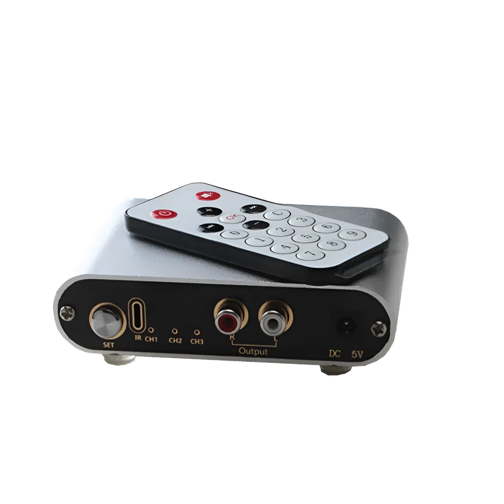 Silver aluminium audio source switch box with remote control for input/output selection.