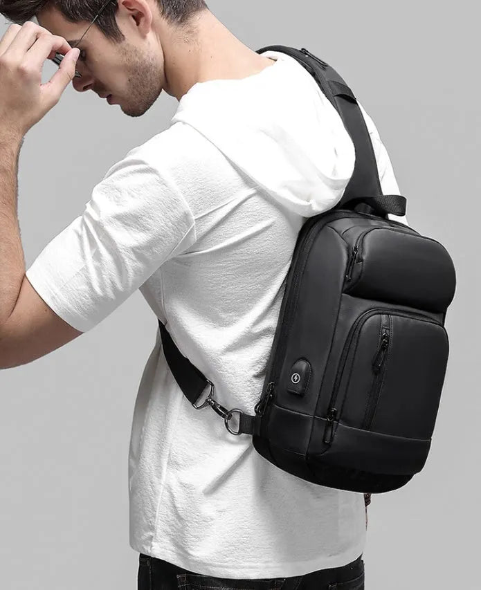 Black medium-sized PVC shoulder bag with zipper, showing internal organiser pockets and an air cushion shoulder strap.