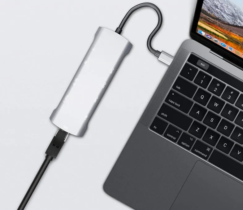 Grey aluminium USB-C docking station with HDMI, VGA, USB 3.0, and PD charging ports