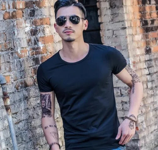 Man wearing a lightweight short sleeve summer T-shirt in a solid colour.