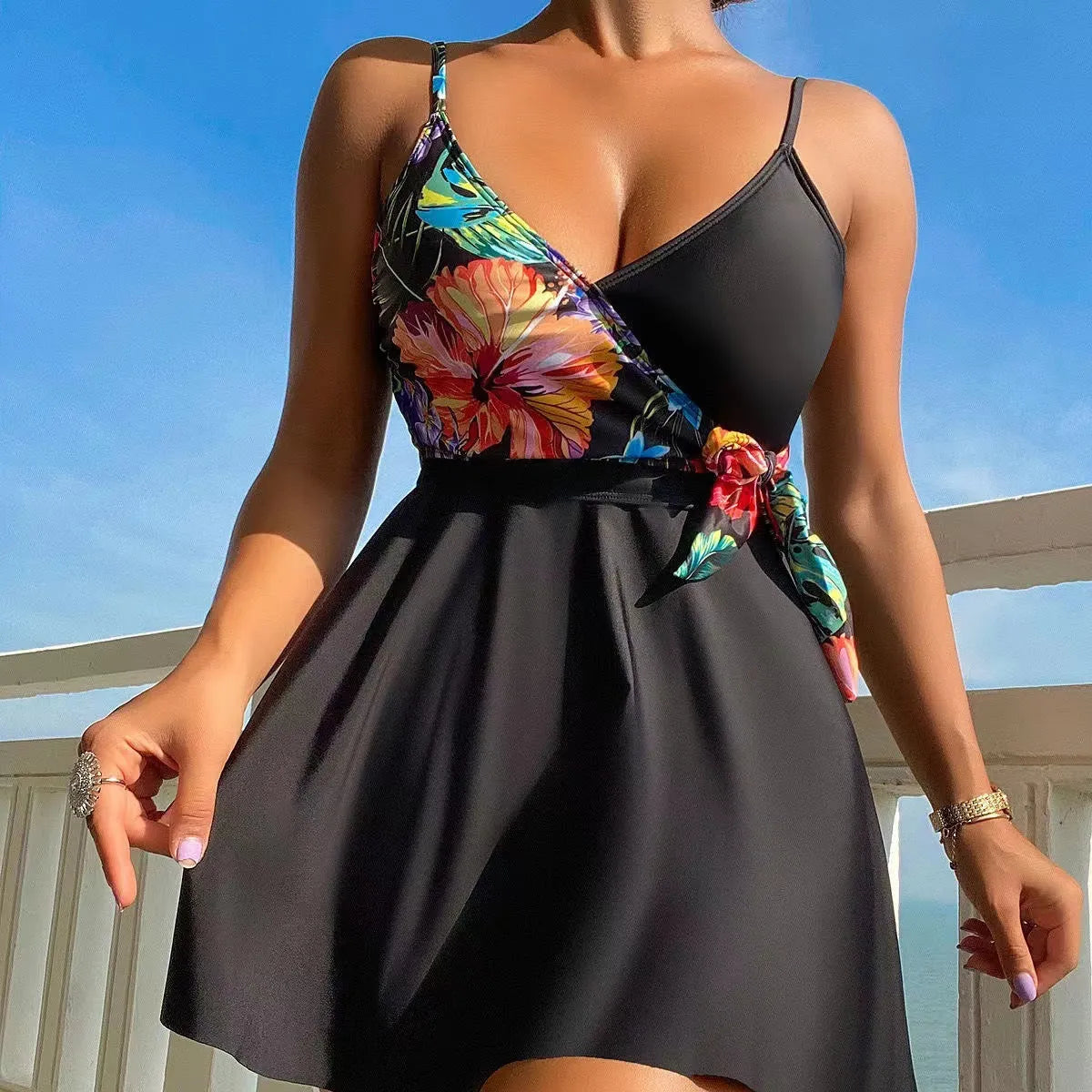 Black women's high waist briefs printed split bikini swimwear laid flat.