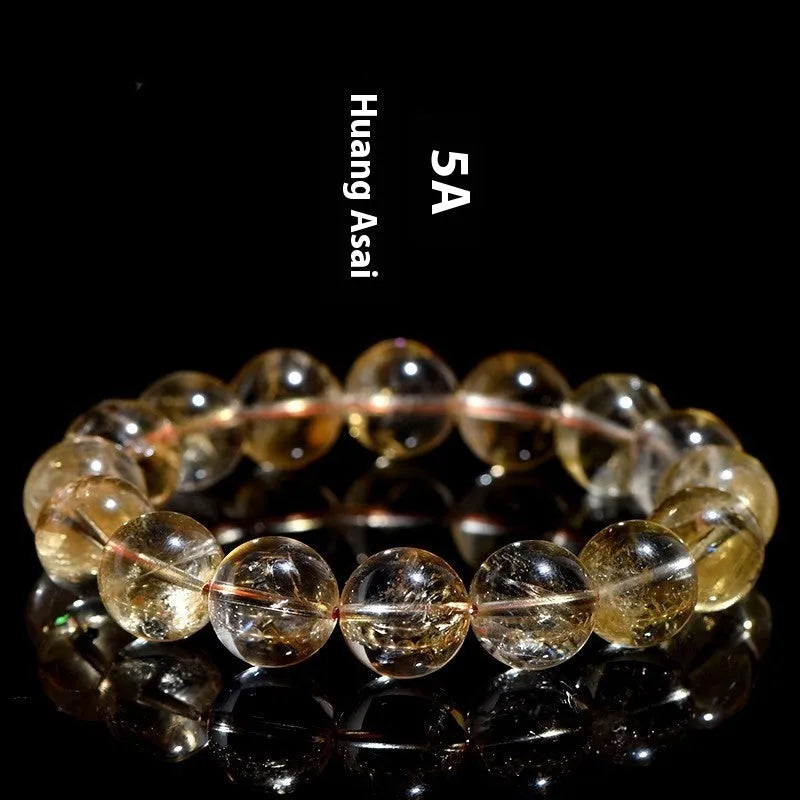 Natural yellow citrine gemstone bracelet showing geometric cut beads on a string.