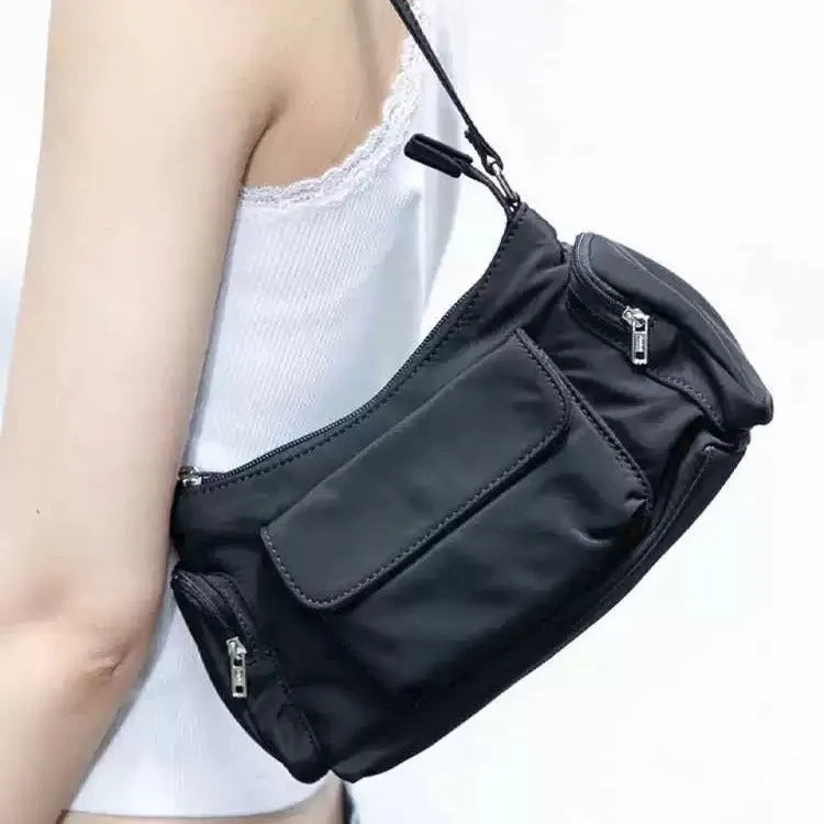 Simple black lightweight double pocket shoulder bag made of PU with side line detail.
