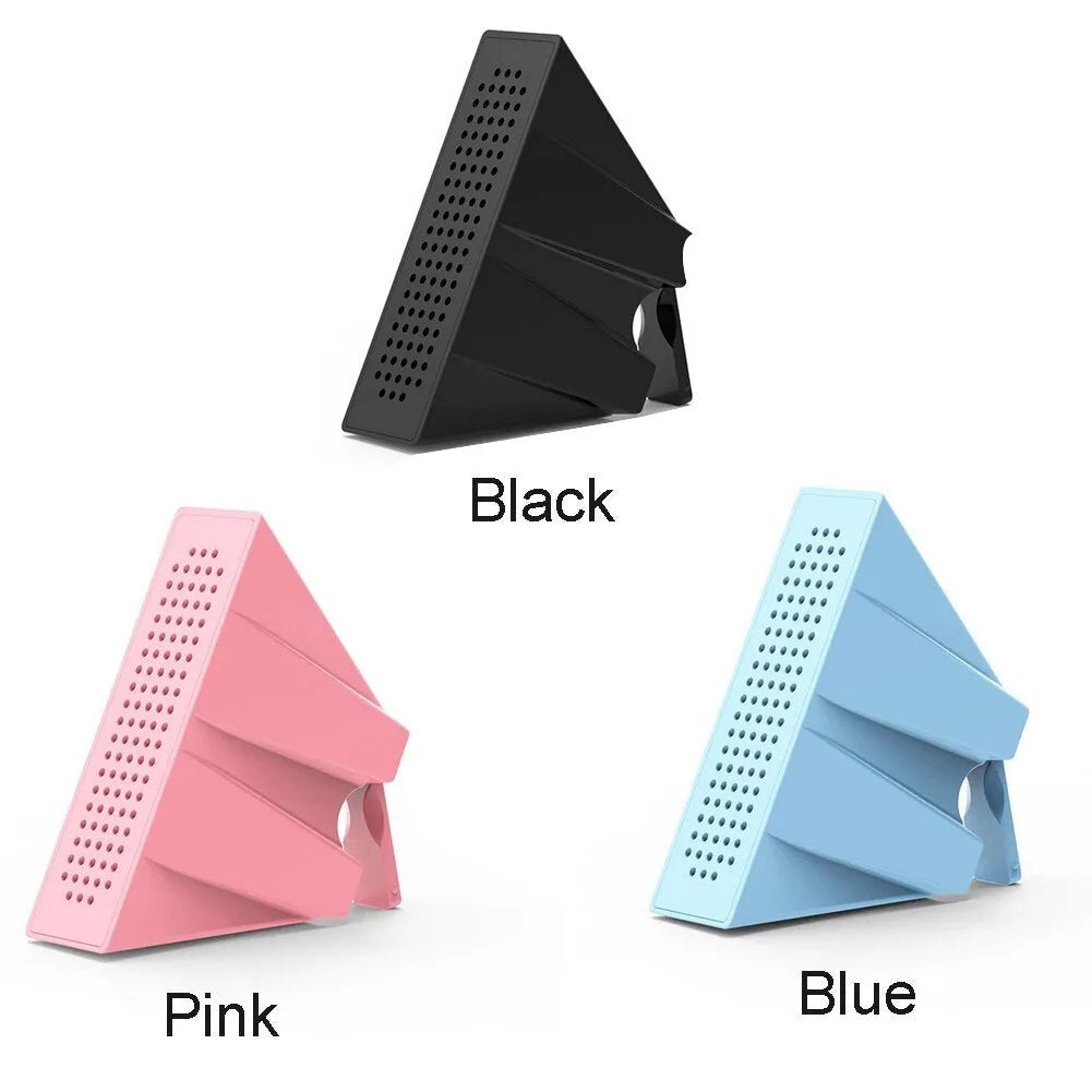 Mini black ABS plastic mobile phone amplifier bracket holding a smartphone on a desktop.