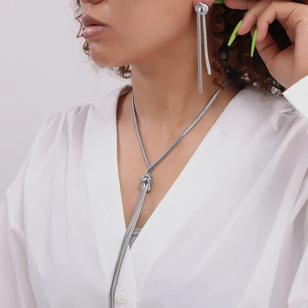 Gold electroplated titanium steel necklace with knotted tassel pendant and matching earrings
