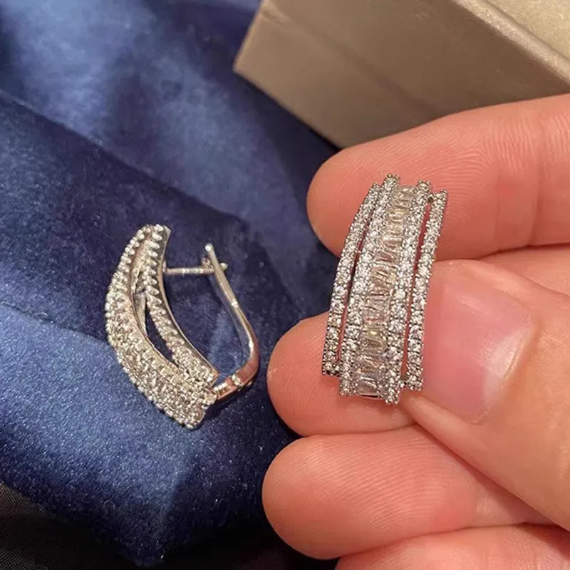 White gold coloured geometric stud earrings with zircon stone accents on copper metal for women
