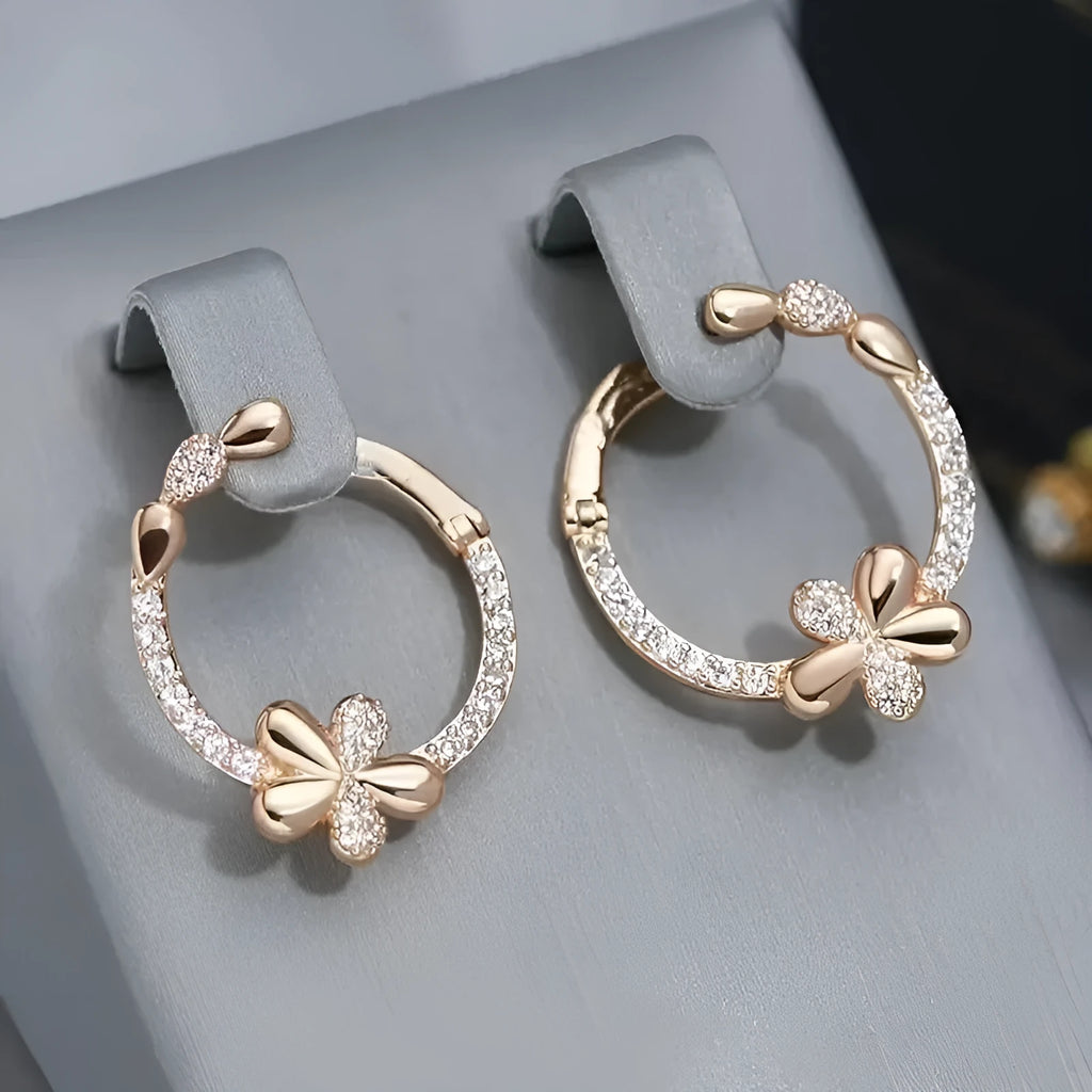 A pair of silver-colour round ring earrings for women on a white background.