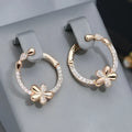 A pair of silver-colour round ring earrings for women on a white background.