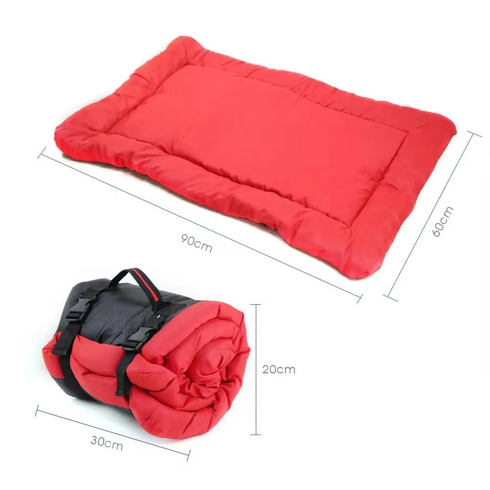 Blue foldable outdoor dog bed showing folded size next to unfolded mat on grass