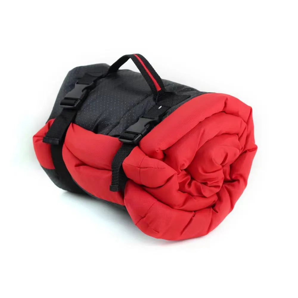 Blue foldable outdoor dog bed showing folded size next to unfolded mat on grass