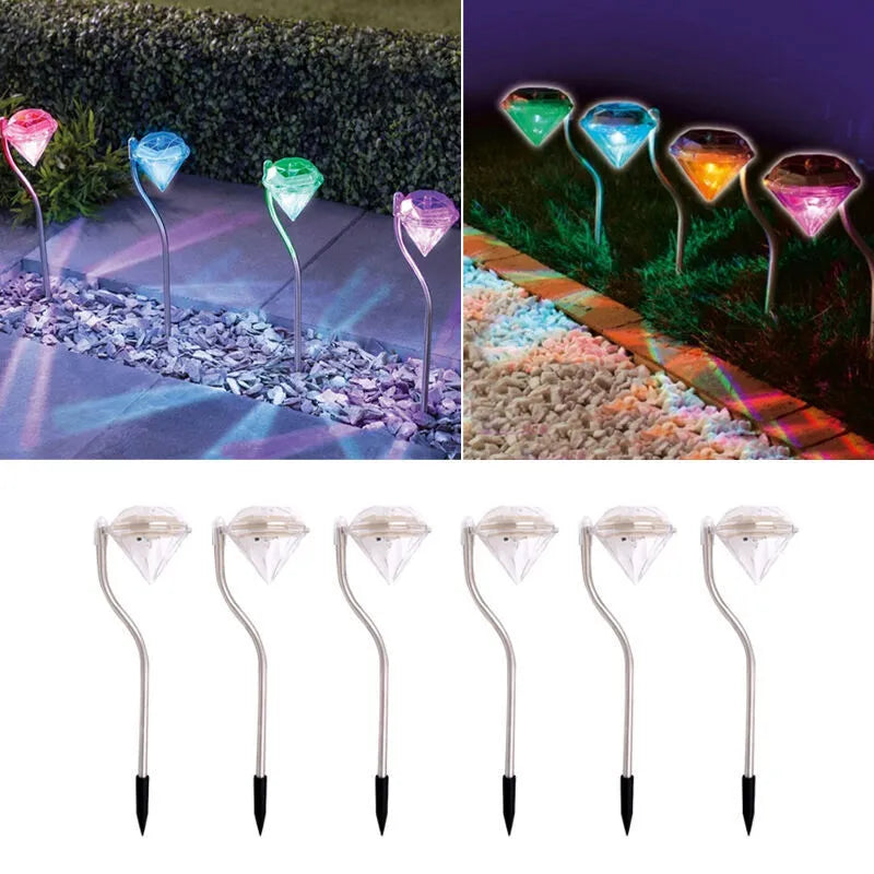 White solar-powered garden spotlight with adjustable head on a metal stake for outdoor use.