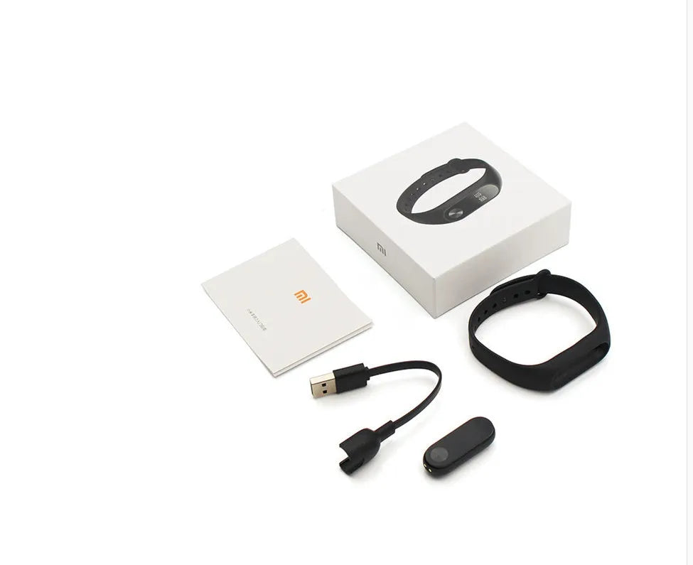 Xiaomi Mi Band 2 black fitness tracker on wrist showing OLED touchscreen display