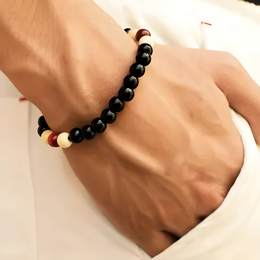 A natural lava stone bead bracelet with ethnic style on a wrist, demonstrating its unisex aromatherapy design.