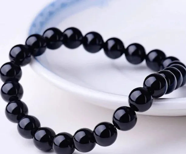 Geometric black onyx bead bracelet for women with elastic cord.