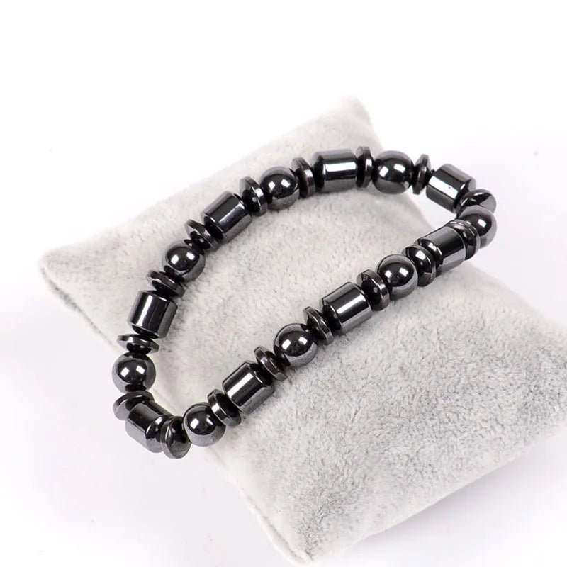 Black magnetic therapy bracelet with a pentagram stone design made from magnetite and hematite.