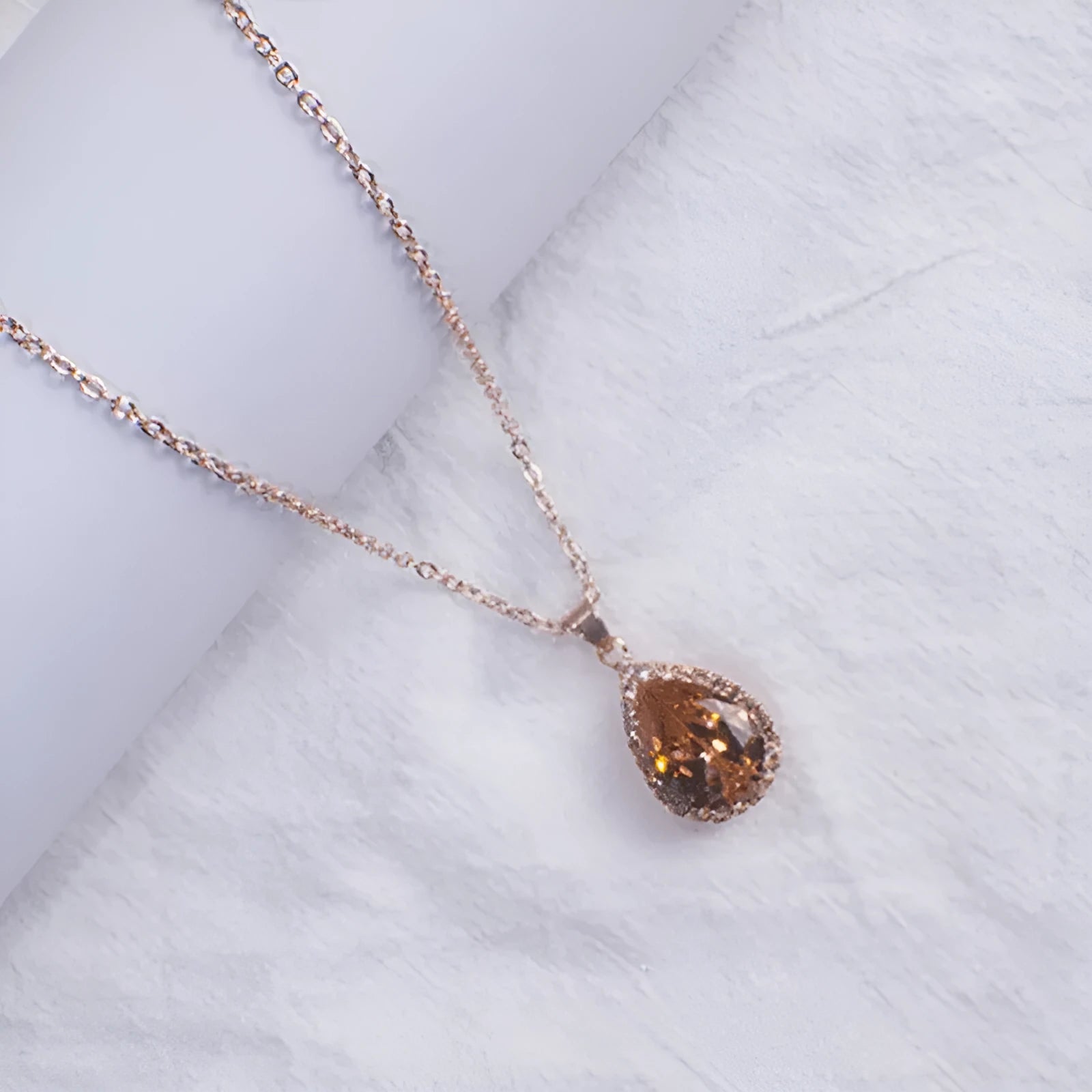 Women's water drop necklace with rose gold rhinestone and pink alloy gemstone pendant.