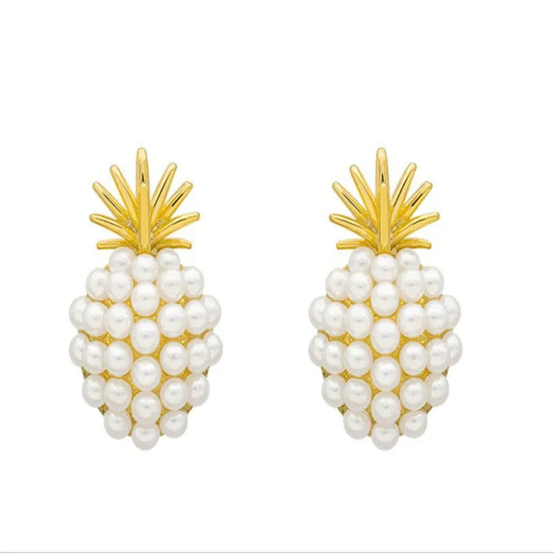 Gold colour Korean-style drop earrings featuring a pineapple and starfish design with pearl and gemstone inlay.