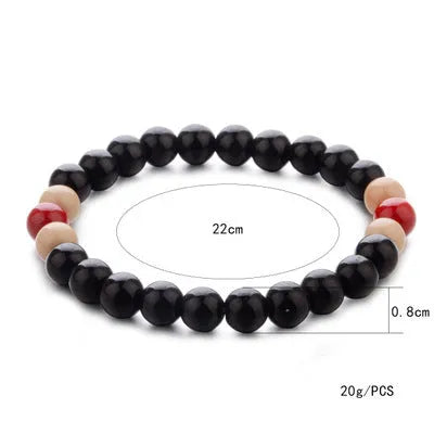 A natural lava stone bead bracelet with ethnic style on a wrist, demonstrating its unisex aromatherapy design.