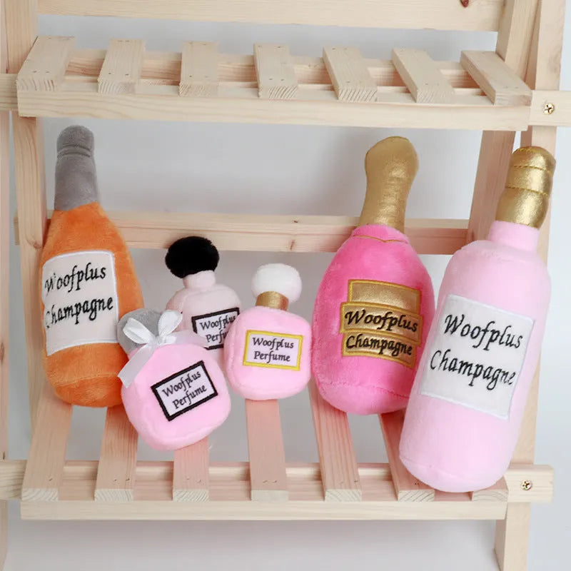 Soft plush pet toy shaped like a wine bottle, shown in various colours including green, red, and black.