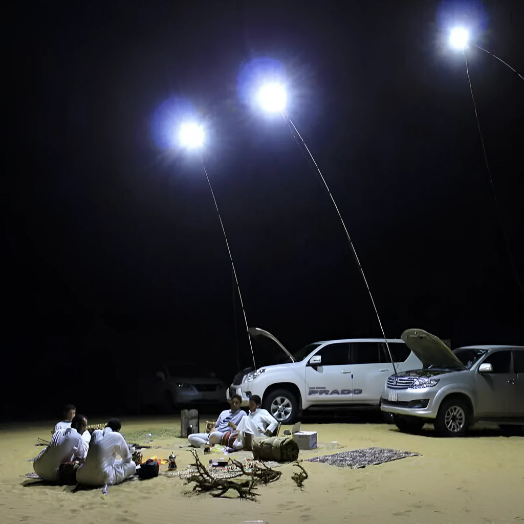 White LED fishing rod light unit mounted on top of an extended telescopic pole, with an RF remote control beside it.