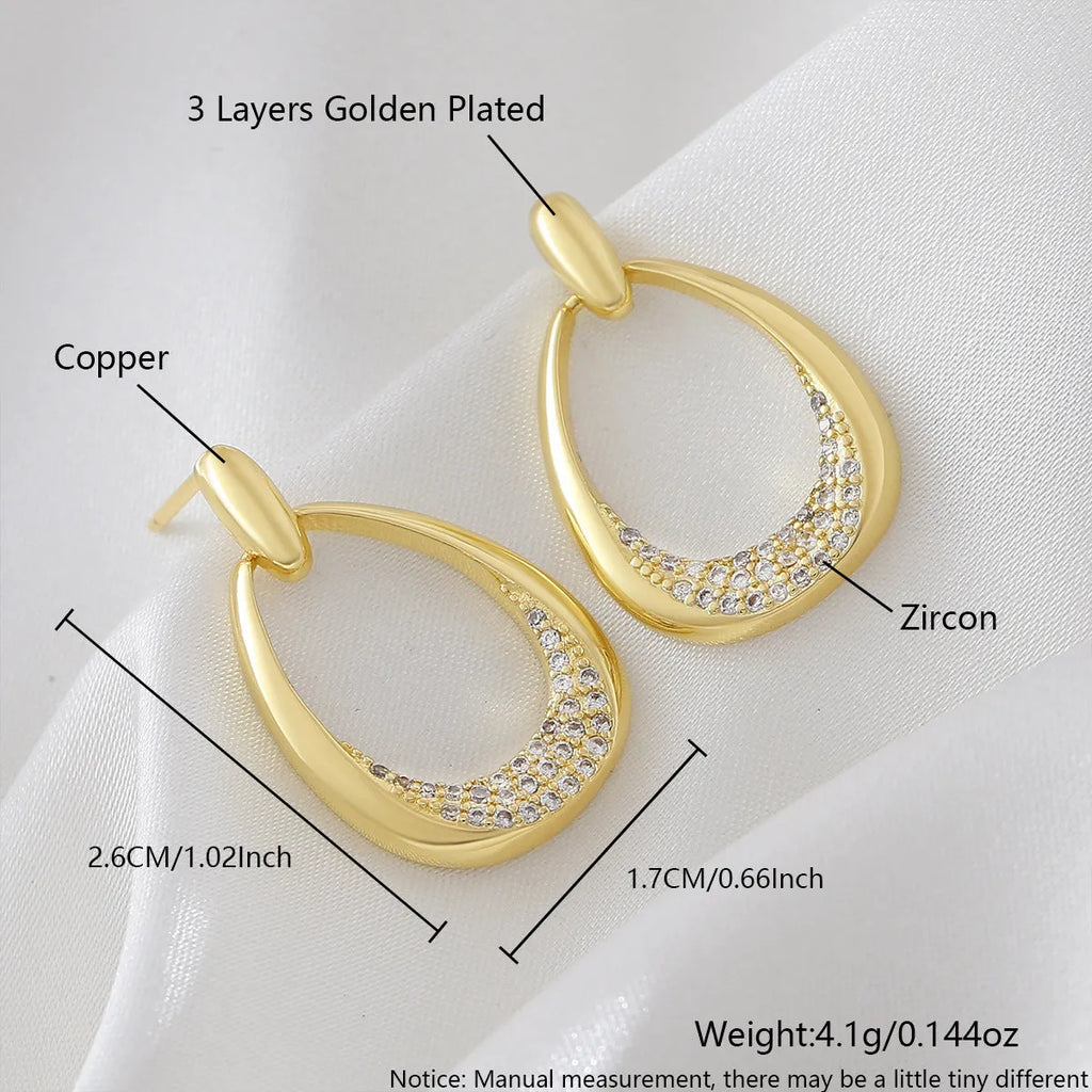 Yellow gold geometric drop earrings with ring design elements measuring 2.6cm