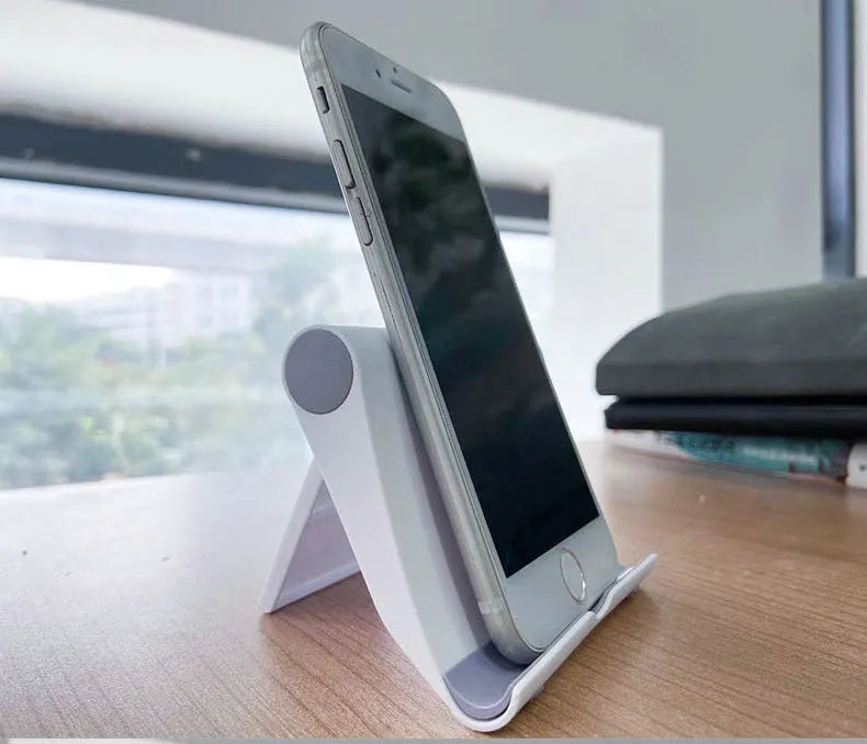 Black PE folding tablet stand holding a mobile phone at an adjustable angle