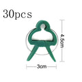 Green plastic and zinc plant fixing clips holding a tomato vine to a garden cane.