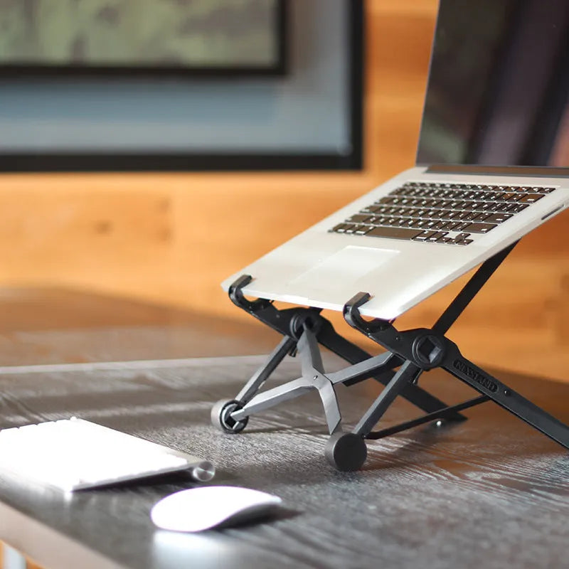 Black folding portable laptop stand with reinforced nylon construction showing adjustable height mechanism