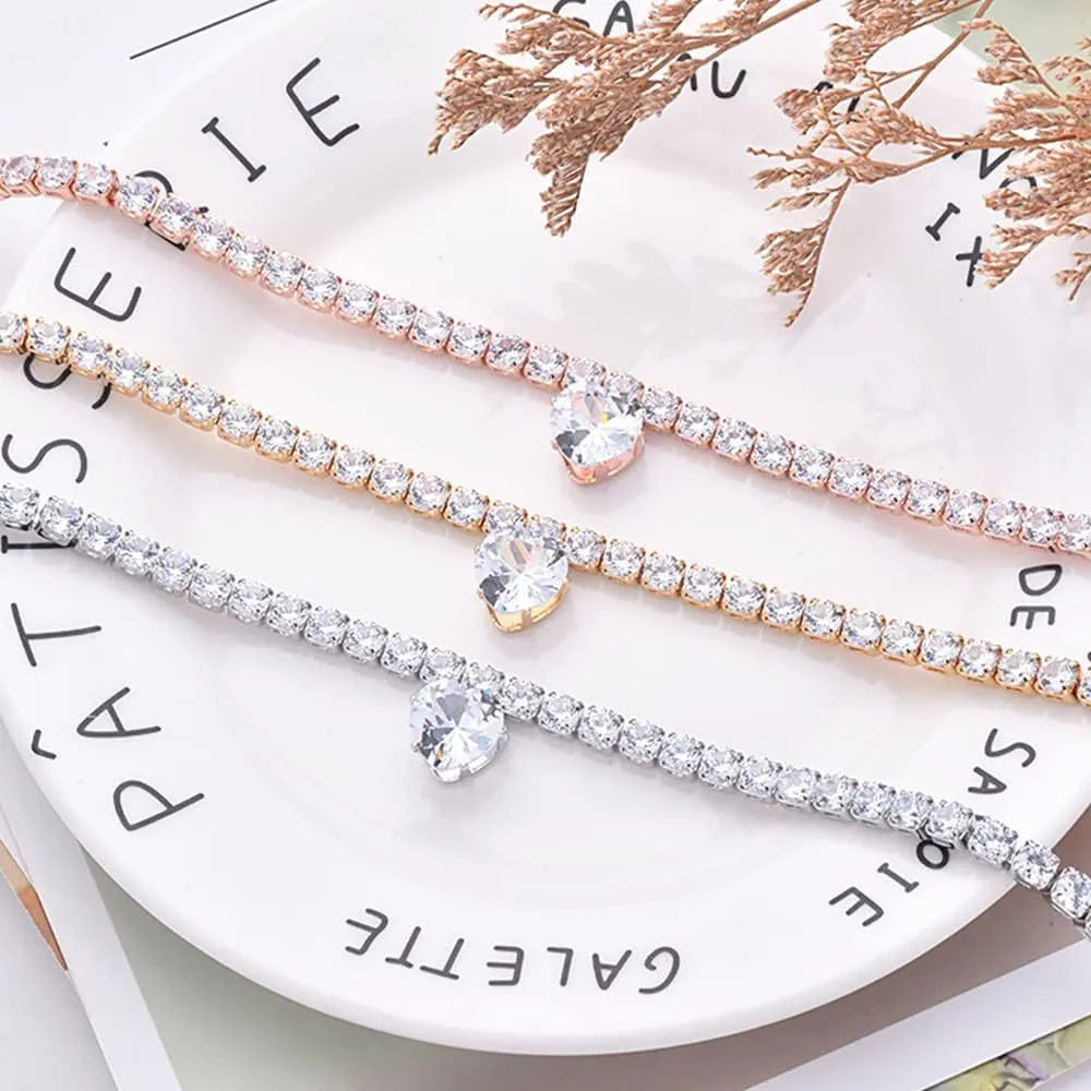 Gold rhinestone heart-shaped collar for a dog or cat on a white background.