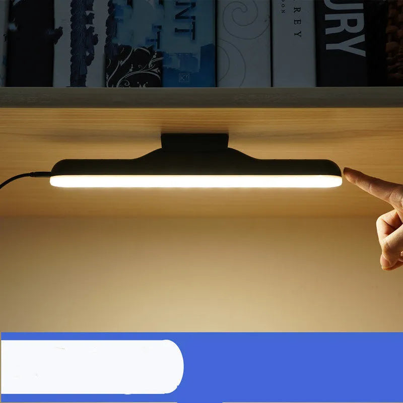 Modern plastic LED desk lamp with touch-sensitive controls on a wooden desk.