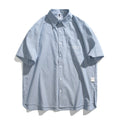 Blue and white striped loose-fitting short-sleeved shirt on a hanger